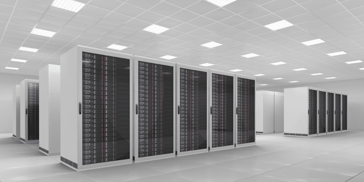 Modern data center with rows of black server racks and bright overhead lighting