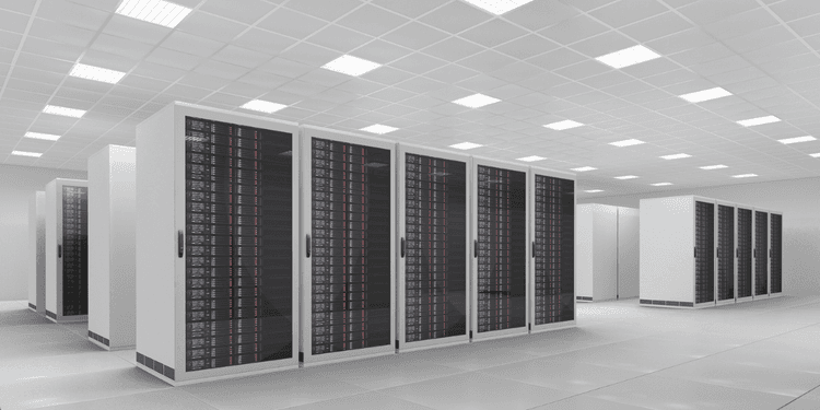 Modern data center with rows of black server racks and bright overhead lighting