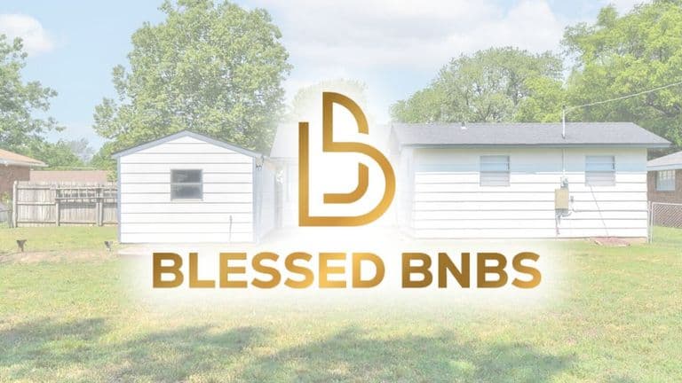 Exterior of a Blessed BNBS property featuring a white house with a well-maintained lawn and a small shed.