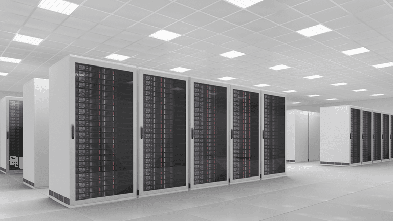 Modern data center with rows of black server racks and bright overhead lighting
