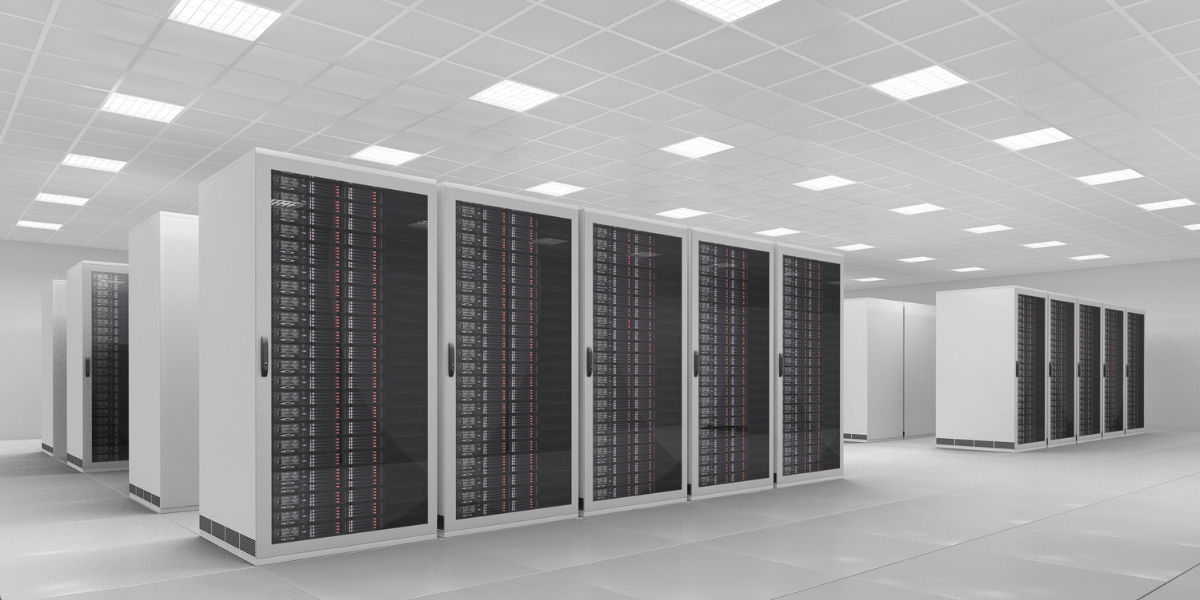 Modern data center with rows of black server racks and bright overhead lighting