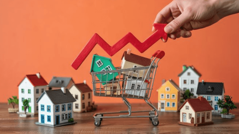 Hand placing a red upward arrow over a shopping cart filled with miniature houses