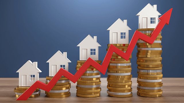 Growing real estate market represented by houses and stacked coins with an upward trend arrow